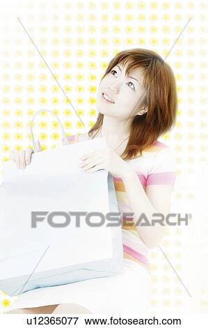 Stock Photo - Young Woman Holding Shopping Bag. Fotosearch