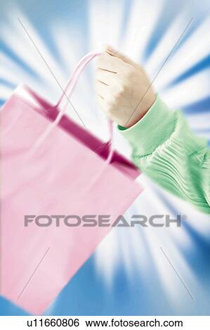 Stock Photograph - Young Woman Holding Shopping Bag. Fotosearch