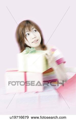 Young Woman Holding Wrapped Box View Large Photo Image Stock Photo - Young Woman Holding Wrapped Box. Fotosearch