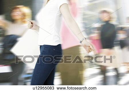 Stock Image - Young Woman Shopping. Fotosearch