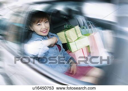 Stock Image - Young Woman Shopping. Fotosearch