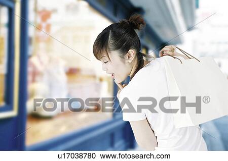 Stock Image - Young Woman Shopping. Fotosearch