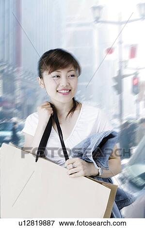 Stock Photo - Young Woman Shopping. Fotosearch