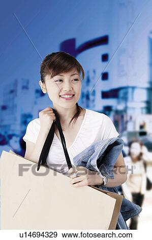 Stock Photo - Young Woman Shopping. Fotosearch