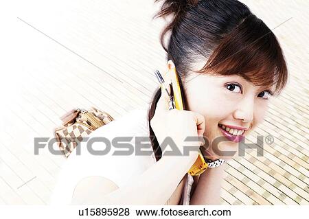 Young Woman Talking On Mobile Phone View Large Photo Image Stock Photo - Young Woman Talking On Mobile Phone. Fotosearch