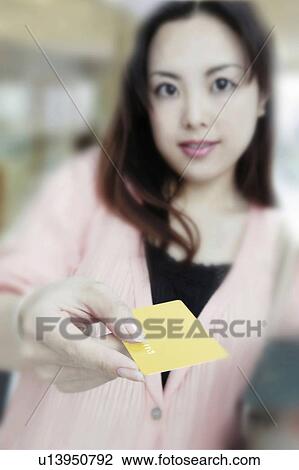 Stock Image - Young Woman Using Card. Fotosearch