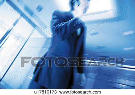 A Business Man talking on the mobile phone View Large Photo Image Stock Image - A Business Man talking on the mobile phone. Fotosearch
