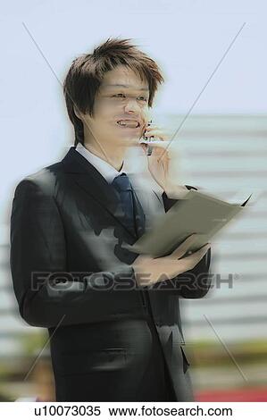 Stock Photography - A Business Man talking on the mobile phone. Fotosearch
