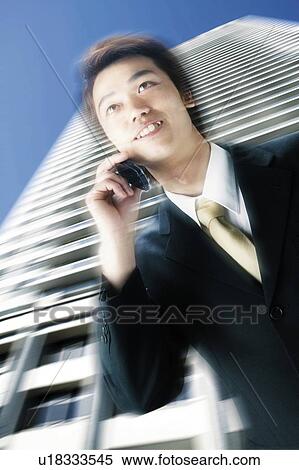 A Business Man talking on the mobile phone View Large Photo Image Stock Photography - A Business Man talking on the mobile phone. Fotosearch