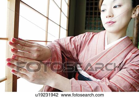 Woman opening a shoji View Large Photo Image Stock Image - Woman opening a shoji. Fotosearch