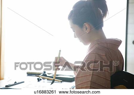 Stock Image - Woman practicing a shodo. Fotosearch