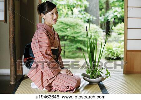 Woman putting on a kimono, kado View Large Photo Image Stock Photograph - Woman putting on a kimono, kado. Fotosearch