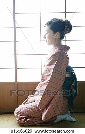 Woman putting on a kimono View Large Photo Image Stock Photo - Woman putting on a kimono. Fotosearch