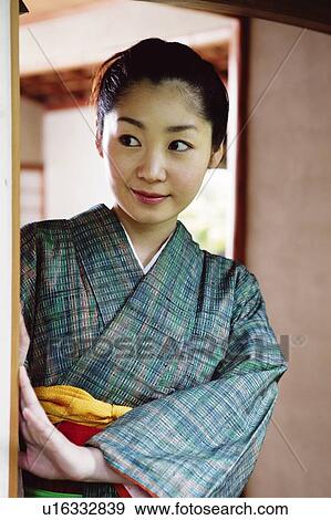 Woman putting on a kimono View Large Photo Image Stock Photo - Woman putting on a kimono. Fotosearch