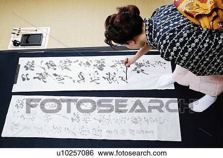 Woman writing charactersin a Japanese paper View Large Photo Image Stock Photograph - Woman writing charactersin a Japanese paper. Fotosearch