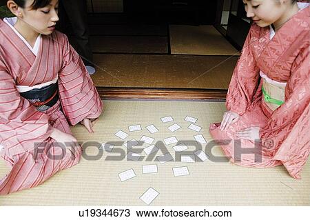 Stock Image - Women playing a card, Karuta. Fotosearch