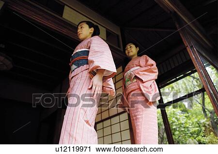 Women putting on a kimono View Large Photo Image Stock Image - Women putting on a kimono. Fotosearch