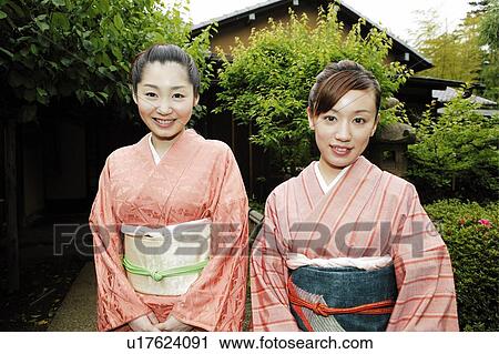 Women putting on a kimono View Large Photo Image Stock Image - Women putting on a kimono. Fotosearch