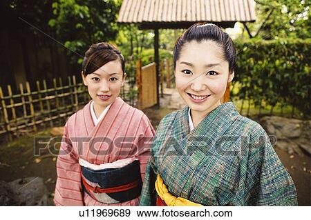 Women putting on a kimono View Large Photo Image Stock Photo - Women putting on a kimono. Fotosearch