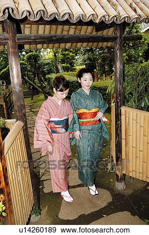 Stock Photo - Women putting on a kimono. Fotosearch