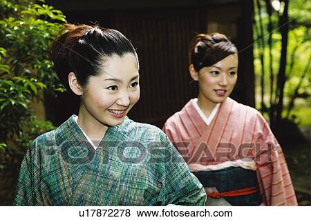 Women putting on a kimono View Large Photo Image Stock Photo - Women putting on a kimono. Fotosearch