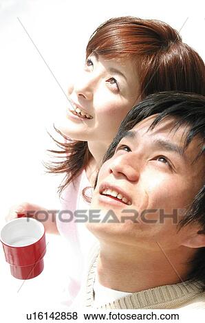 Stock Photo - Couple relaxing in the room. Fotosearch