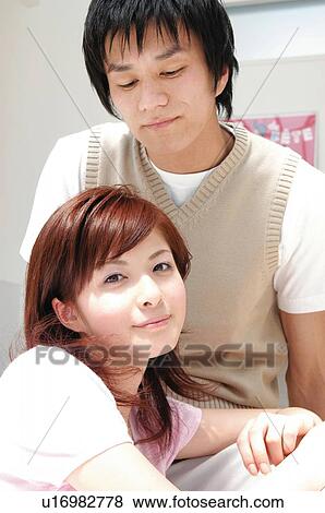 Stock Photo - Couple relaxing in the room. Fotosearch