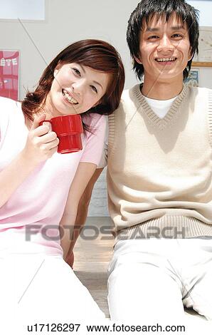 Stock Photo - Couple relaxing in the room. Fotosearch