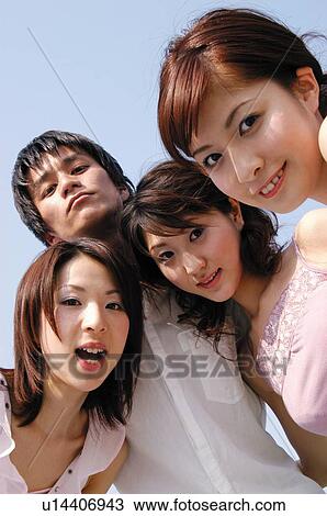 Stock Image - Group of friends under the sky. Fotosearch