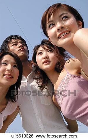 Stock Photograph - Group of friends under the sky. Fotosearch