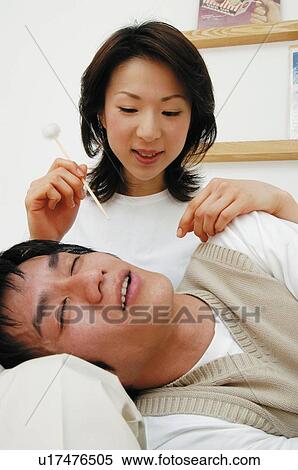 Stock Photography - Man resting his head on woman's lap. Fotosearch