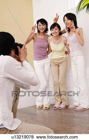 Man taking a picture of girlfriends View Large Photo Image Stock Photo - Man taking a picture of girlfriends. Fotosearch