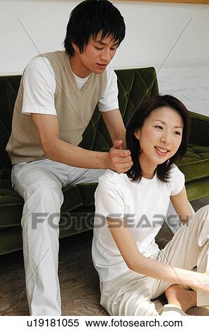 Men massaging woman's shoulder View Large Photo Image Stock Photography - Men massaging woman's shoulder. Fotosearch