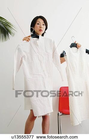 Stock Photo - Woman choosing clothes. Fotosearch