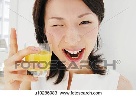 Woman drinking a juice, Close-up View Large Photo Image Stock Image - Woman drinking a juice, Close-up. Fotosearch