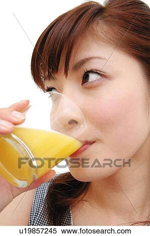 Woman drinking a juice, Close-up View Large Photo Image Stock Photography - Woman drinking a juice, Close-up. Fotosearch