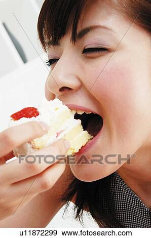 Woman eating a cake, Close-up View Large Photo Image Stock Photo - Woman eating a cake, Close-up. Fotosearch