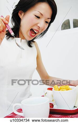 Picture - Woman eating lunch. Fotosearch
