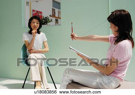 Stock Photograph - Woman making a sketch.. Fotosearch