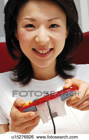 Woman playing a game, Close-up View Large Photo Image Stock Photograph - Woman playing a game, Close-up. Fotosearch