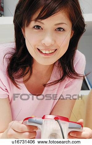 Stock Photograph - Woman playing a game, Close-up. Fotosearch