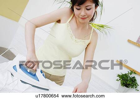 Picture - Woman pressing clothes. Fotosearch