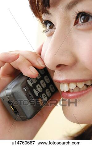 Stock Photo - Woman using a portable phone, Close-up. Fotosearch