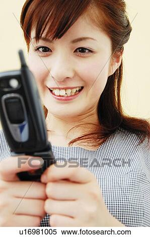 Stock Photography - Woman using a portable phone, Close-up. Fotosearch
