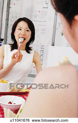Women eating lunch View Large Photo Image Stock Photograph - Women eating lunch. Fotosearch