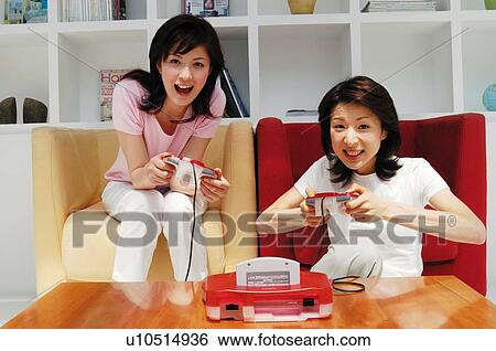 Women playing a game View Large Photo Image Stock Photograph - Women playing a game. Fotosearch