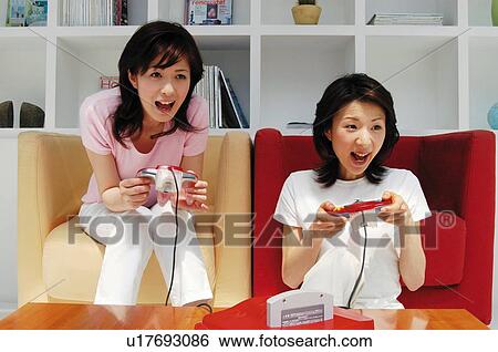 Women playing a game View Large Photo Image Stock Photograph - Women playing a game. Fotosearch