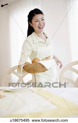 Stock Photography - Young Woman Carrying Basket. Fotosearch