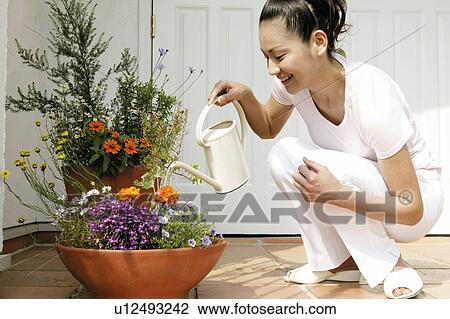 Young Woman Holding Pot For Plant View Large Photo Image Stock Image - Young Woman Holding Pot For Plant. Fotosearch