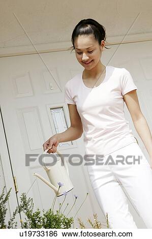Young Woman Holding Pot For Plant View Large Photo Image Stock Photograph - Young Woman Holding Pot For Plant. Fotosearch